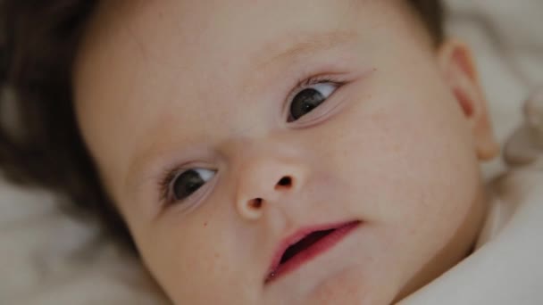 Beautiful little girl woke up and smiles at the camera — Stock Video