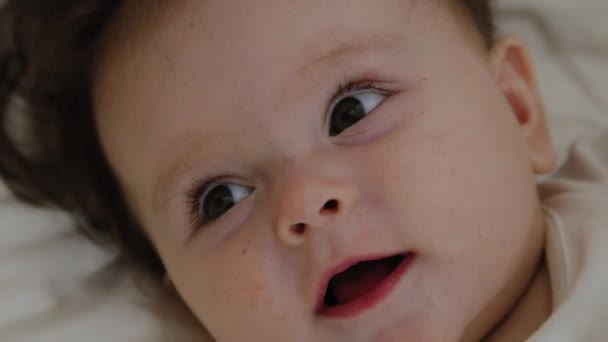 Beautiful little girl woke up and smiles at the camera — Stock Video