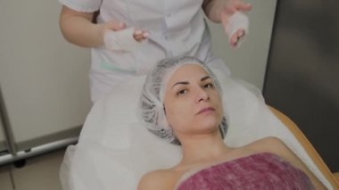 Bir kadın güzellik salonunda özel mendiller ile temizlenir.