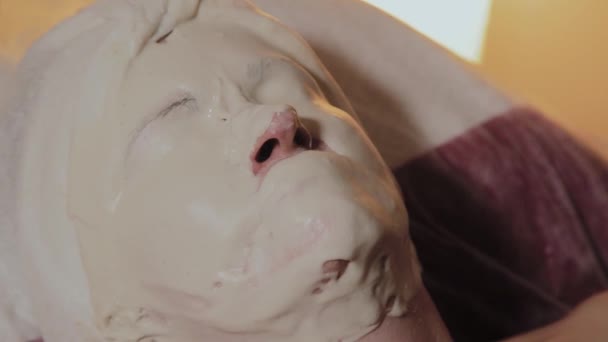Доглянута літня жінка носить маску на процедурі в салоні краси . — стокове відео