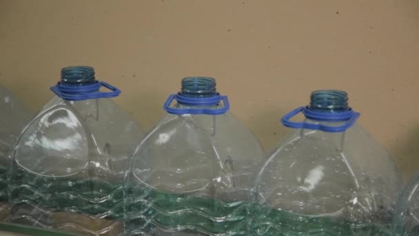 Plastic bottle manufacturing line. Plastic molding bottling factory. Blanks of plastic bottles in the factory. — Stock Video