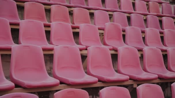 Empty red sports stadium seating before a big game. — Stock Video