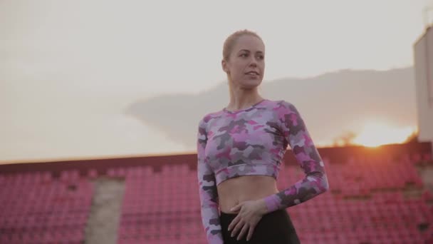 Mädchen in Sportkleidung posiert im Stadion. — Stockvideo