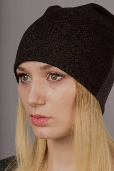 Portrait d'une belle jeune fille dans une coiffure élégante avec un maquillage naturel sur un fond gris . — Photo