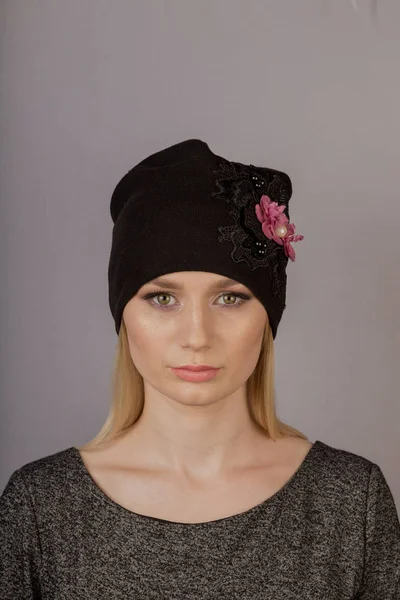 Hermosa chica con maquillaje natural en un tocado sobre un fondo gris . — Foto de Stock