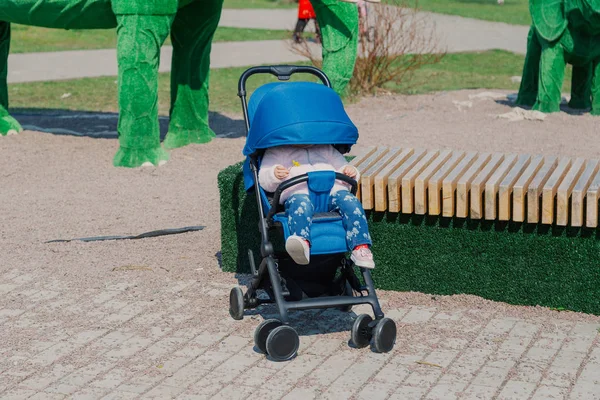 Little beautiful girl sitting in the stroller. — Stock Photo, Image