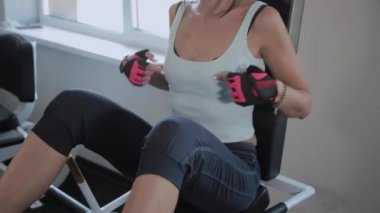 Güzel aktif kadın spor salonunda spor salonunda bacaklar sallar.