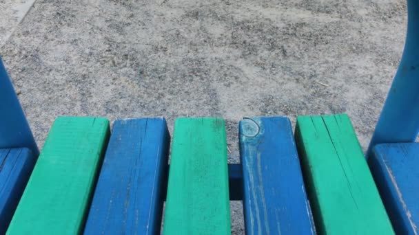 Wooden bench in the park. Multicolored boards. — Stock Video