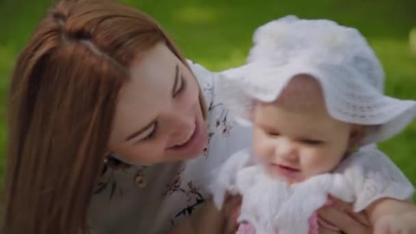 Happy mother playing with baby on bedspread. — Stock Video