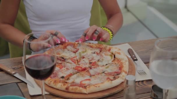 Gyönyörű nő, aki pizzát evett egy étterem teraszán. — Stock videók