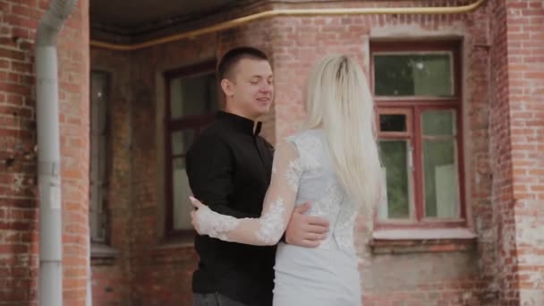 Beautiful happy couple in love dancing in the old courtyard. — Stock Video