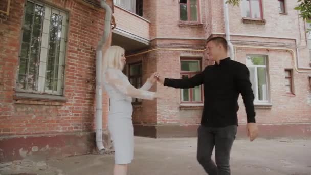 Beautiful happy couple in love dancing in the old courtyard. — Stock Video