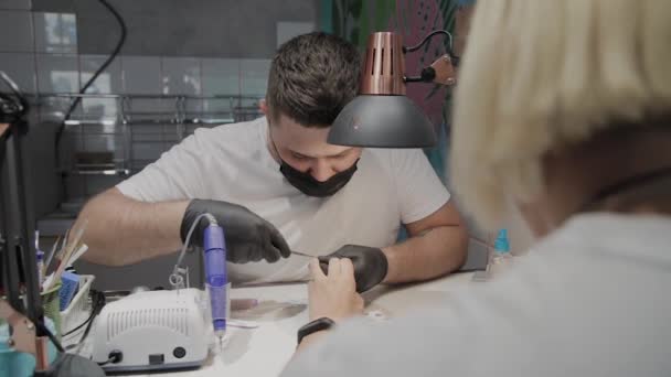 Professional manicurist man removes cuticles with special scissors. — Stock Video