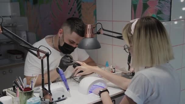 L'uomo manicurista professionale dipinge unghie di ragazze . — Video Stock