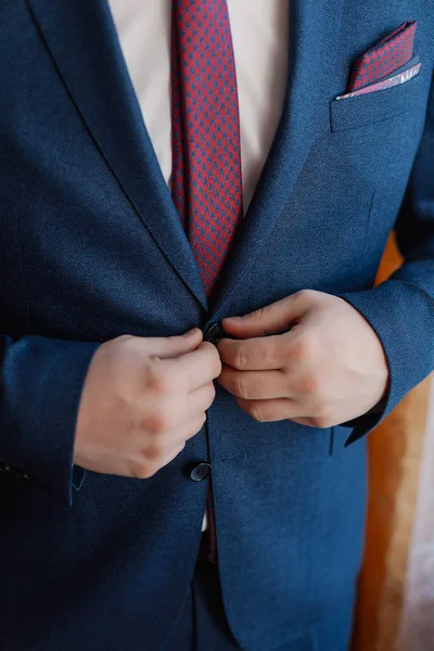 A man and a successful businessman straightens his jacket. — Stock Photo, Image