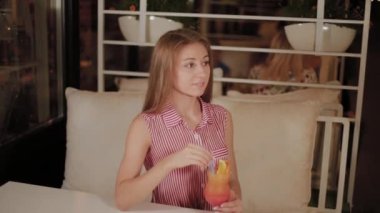 Bir kafede güzel bir taze parlak parlak akşam kokteyli ile güzel kız.