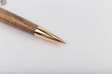 Exotic, Luxury Iroko wood bolt-action pen with chrome metal fixtures and beautiful knot in the wood - Product Photo Ballpoint Pen Handmade Hand Crafted. clipart