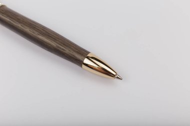 Exotic, Luxury Iroko wood bolt-action pen with chrome metal fixtures and beautiful knot in the wood - Product Photo Ballpoint Pen Handmade Hand Crafted. clipart