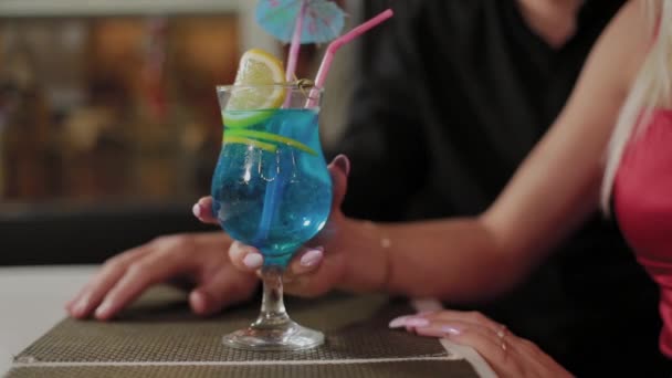 Hermosa chica y chico con cócteles frescos en el café de la noche . — Vídeo de stock