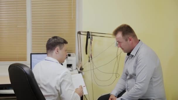 Чоловік лікар дає пацієнту результати дослідження . — стокове відео