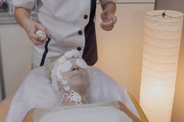 Profesyonel güzellik bir güzellik salonunda bir kadın için prosedür yapar.