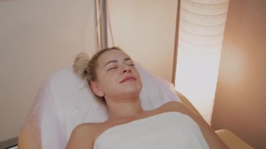 Yalan ve yüz bakım yordam lüks spa salonu bekleyen bornoz güzel genç kadın