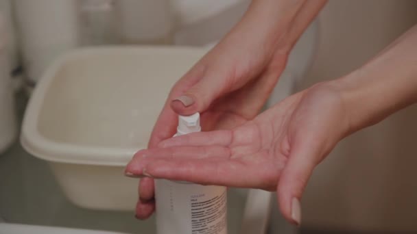 Professional beautician applies cream on his hands. — Stock Video