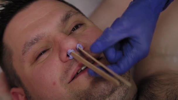 Profesionální beautik voskuje nos na mandle. — Stock video