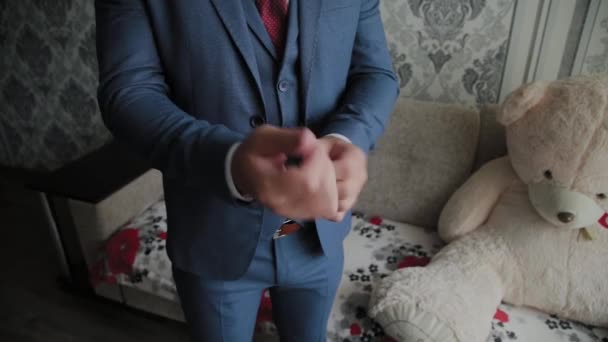 Businessman man straightens cuffs before going out. — Stock Video