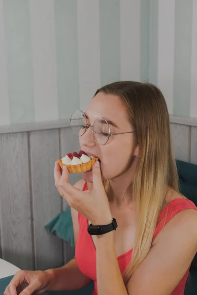 Menina em um café come sobremesas doces e frescas . — Fotografia de Stock