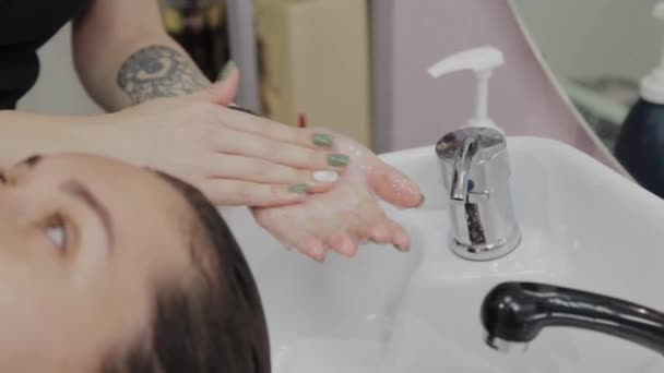 Coiffeuse met shampooing sur les mains . — Video