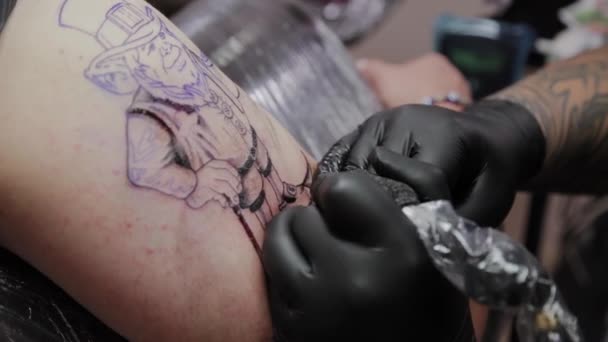 Tatoueur professionnel fait un tatouage sur le bras d'un homme . — Video