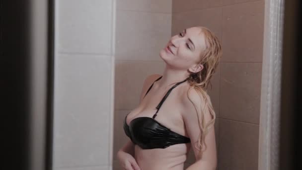 Beautiful girl washes in the shower. — Stockvideo