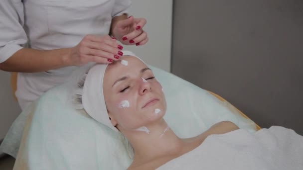 Профессиональный косметолог делает массаж лица в салоне красоты . — стоковое видео