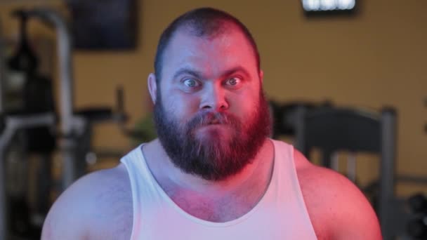 Groot gezicht van een boosaardige man met een baard in neon licht. — Stockvideo