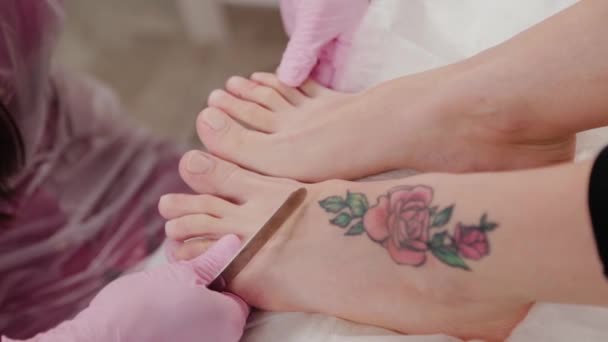 Pedicure mestre corta uma mulher unhas dos pés . — Vídeo de Stock