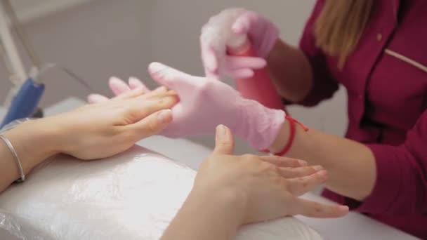 Manikiurzystka dezynfekuje paznokcie klienta. — Wideo stockowe