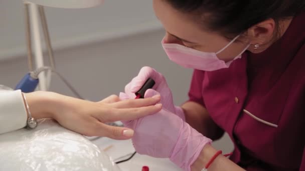 Manucure polit les ongles avec un client dans un salon de beauté. — Video