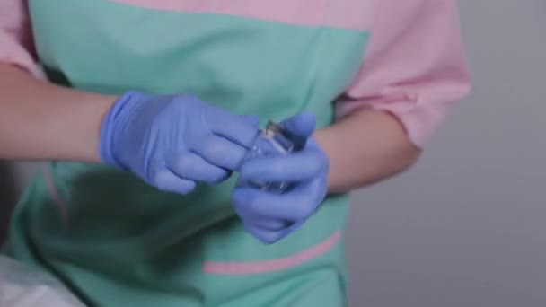 Professional beautician disinfects a container for stirring a face mask. — Stock Video