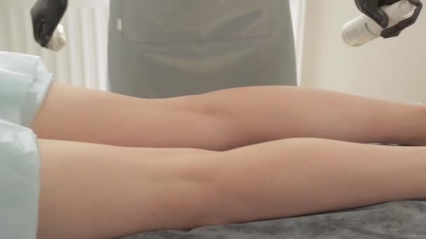 Esteticista prepara las piernas de una joven para shugaring . — Vídeo de stock