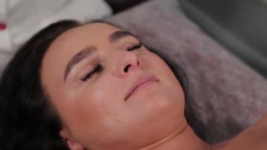 Güzel bir kadın güzellik salonundaki kanepede yatıyor..
