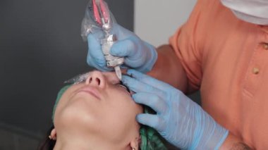 Kalıcı bir makyöz, bir kadının göz kapaklarına dövme yaptırır..