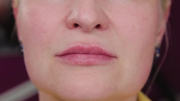 Beautiful woman after lip augmentation. Portrait of a middle aged woman. — Stock Video