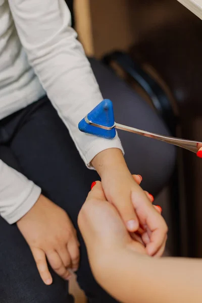 Woman child neurologist examines the girl in the office.