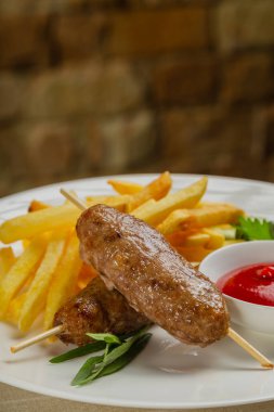 Kızarmış patates ve domates soslu taze kebap..