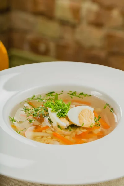 Fresh soup with vegetables, meat and eggs in a white plate. — Stock Photo, Image