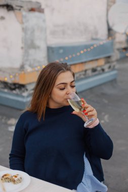 Elinde bir bardak şampanyayla güzel bir kadın.