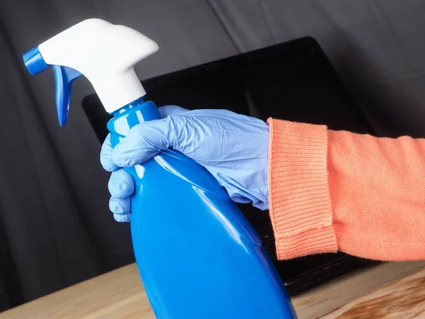 Hands of asian adult woman cleaning and sanitizing home office devices and objects to prevent corona covid-19 virus contagion infection