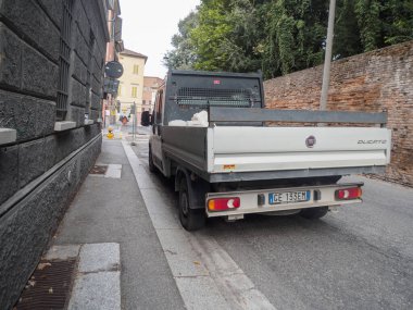 Cremona, İtalya 16 Eylül 2025 Fiat Ducato III kamyonet, düz kamyonlu beyaz bir iş aracı, dar bir caddeye park edilmiş eski bir taş duvar ve tuğla bir duvarın yanında,