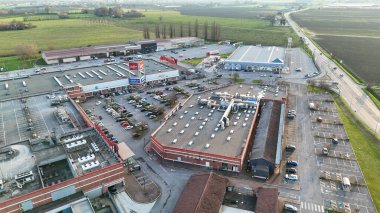 Castelvetro PC, İtalya - 6 Eylül 2025 'te İtalya' nın Piacenza kentindeki Castelvetro Piacentino 'nun hareketli ticari alanının canlı perakende alanları ve işlek otoparkları